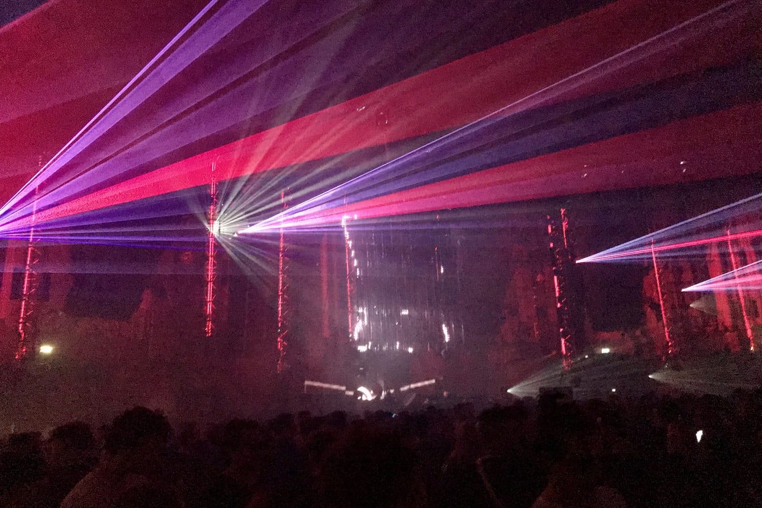 Lasers over the crowd at an electronic music rave (illustrative image)